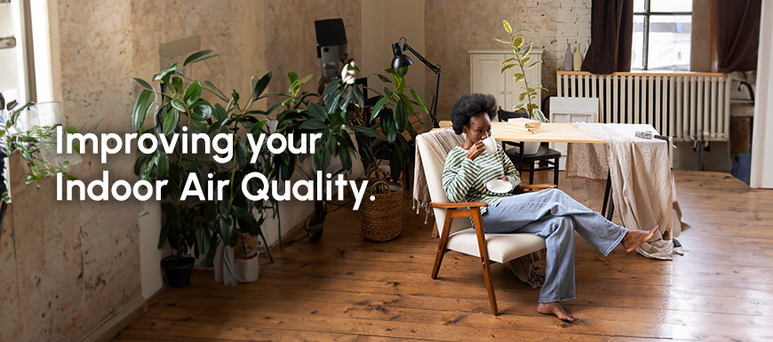 Woman sitting in comfortable living room with plants